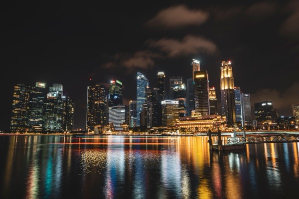 Illuminated waterfront skyscrapers reflected in the water at night